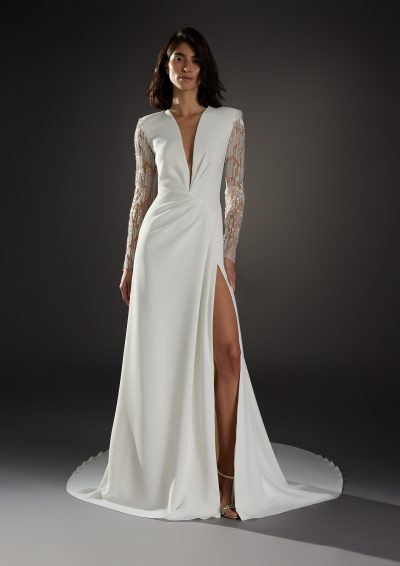 Afbeelding van de Atelier Pronovias Nouveau jurk met diepe V-hals en lange mouwen.