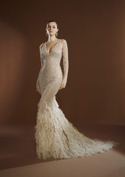 Model draagt de Elisabetta Franchi X Pronovias Queen Be trouwjurk met kristalversieringen en veren, vooraanzicht.